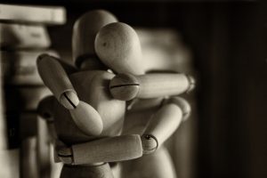 Wooden figures hugging