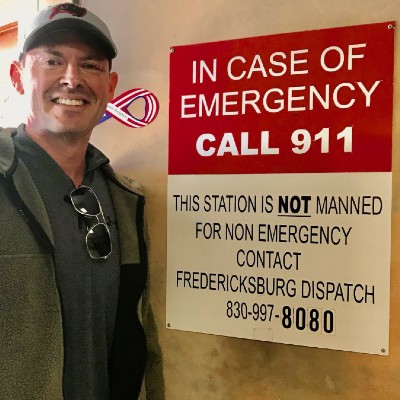 Aaron in front of an emergency sign